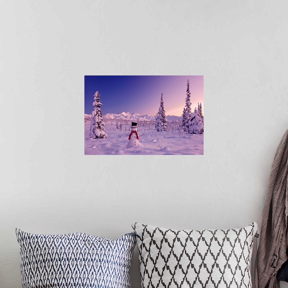 A bohemian room featuring Large canvas photo of a snowman sitting in a snowy landscape with mountains in the distance and s...