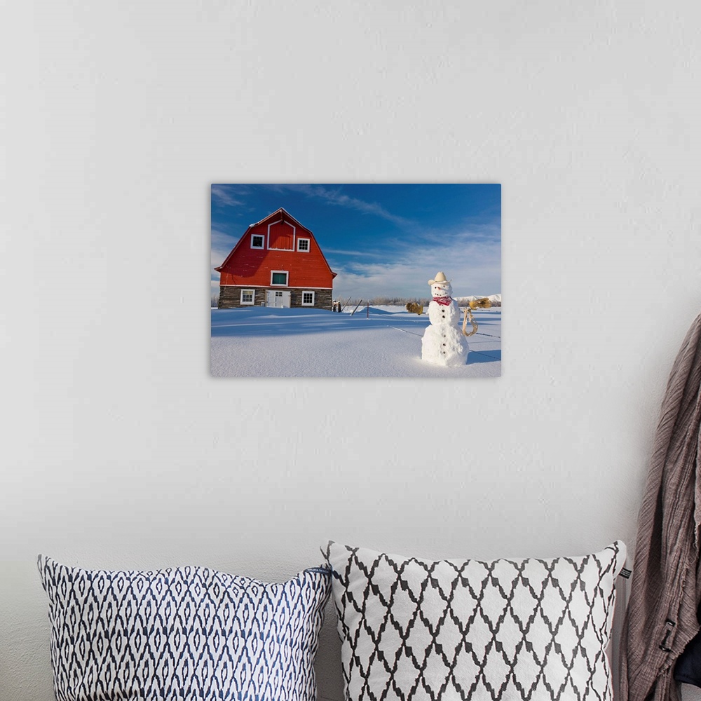 A bohemian room featuring Snowman dressed up as a cowboy standing in front of a vintage red barn