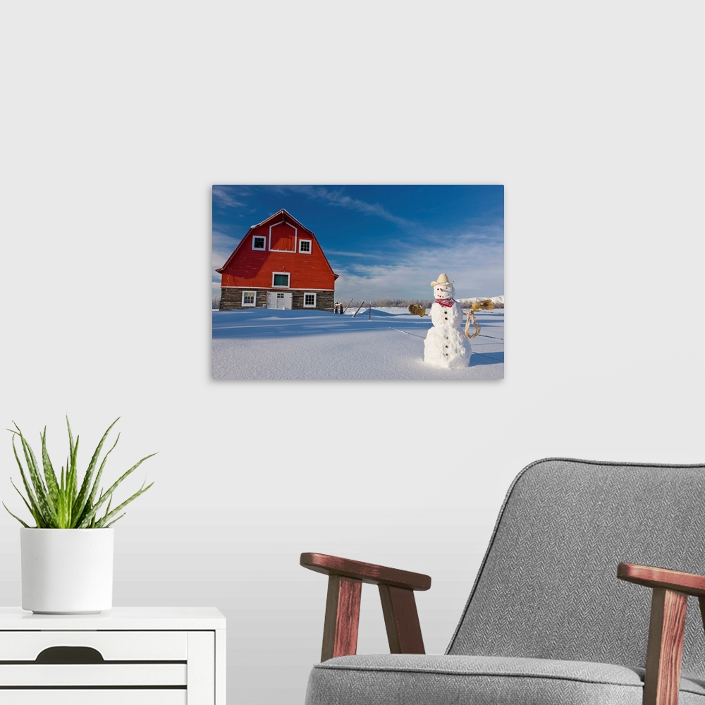 A modern room featuring Snowman dressed up as a cowboy standing in front of a vintage red barn