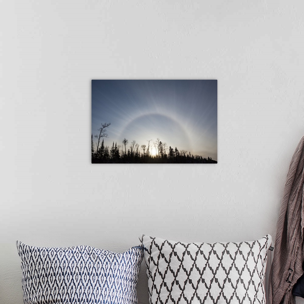 A bohemian room featuring Sun halo in blue sky over silhouetted trees; Sault St. Marie, Michigan, United States of America