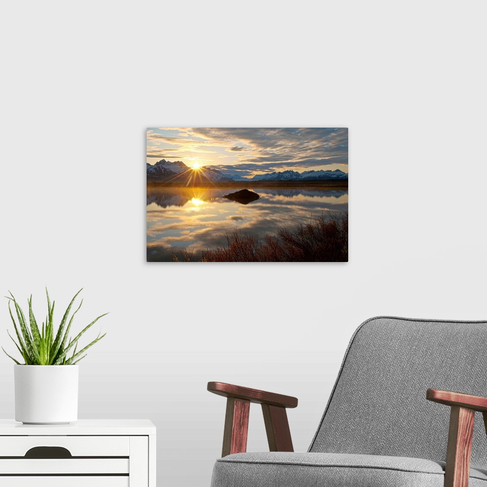 A modern room featuring Sun rises over the Chugach Mountains at a pond with a beaver lodge along the Copper River Highway...