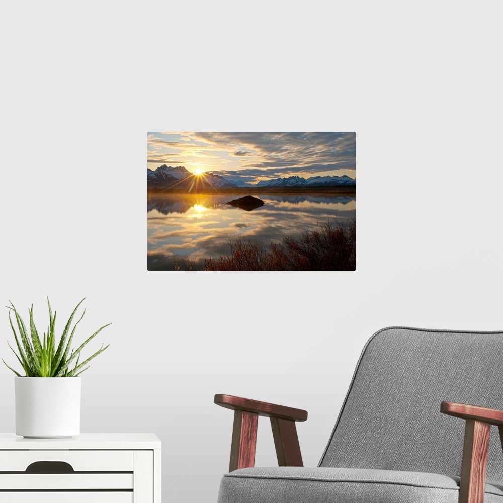 A modern room featuring Sun rises over the Chugach Mountains at a pond with a beaver lodge along the Copper River Highway...
