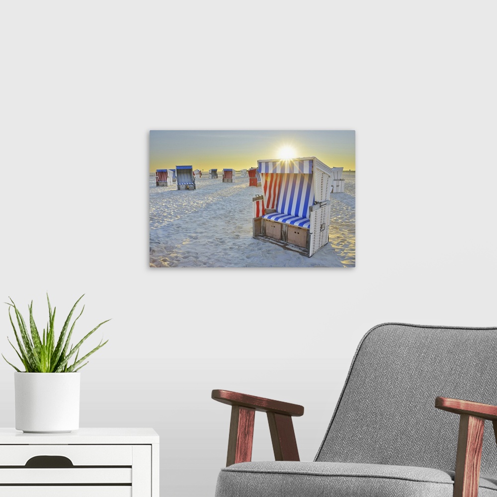 A modern room featuring Sun Rising over Beach Chairs at Beach, Norderdeich, Sankt Peter-Ording, North Sea, Schleswig-Hols...