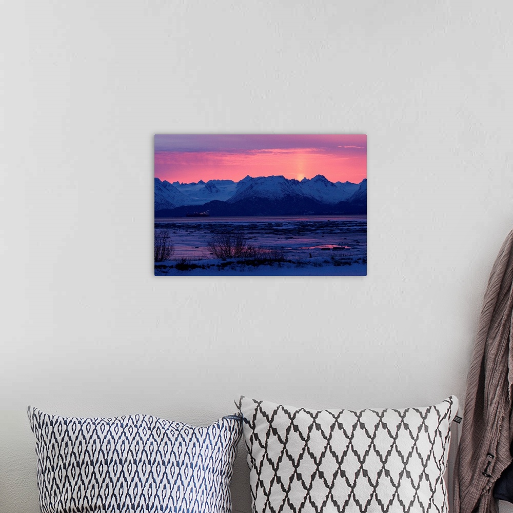 A bohemian room featuring Photo print of rocky mountains with the sun setting behind them.