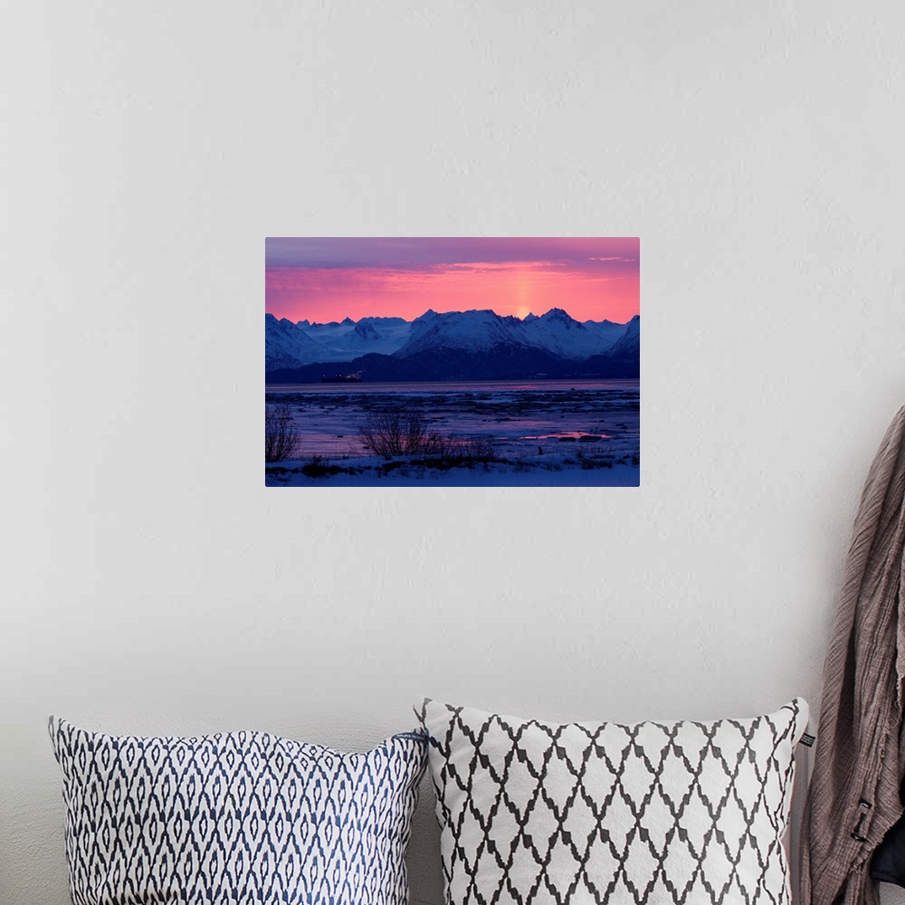 A bohemian room featuring Photo print of rocky mountains with the sun setting behind them.