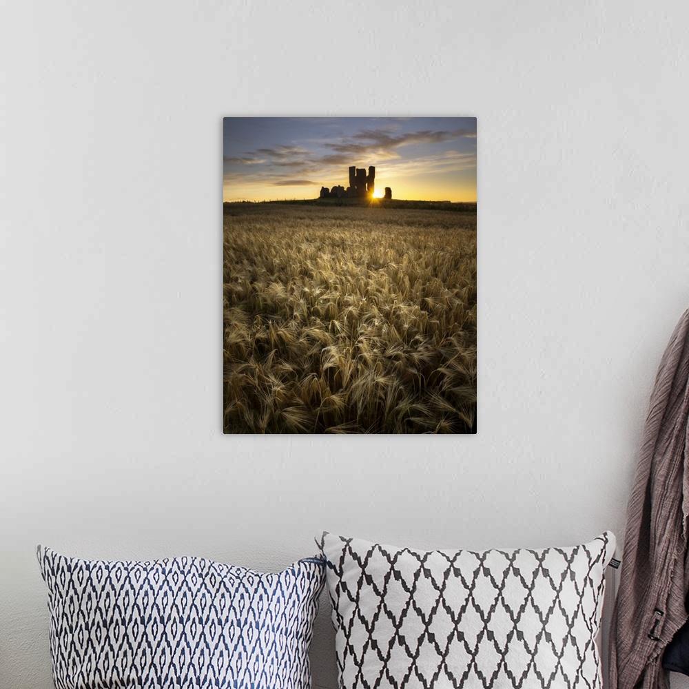 A bohemian room featuring Sunlight breaking through the remains of St James' church and illuminating a field of wheat.
