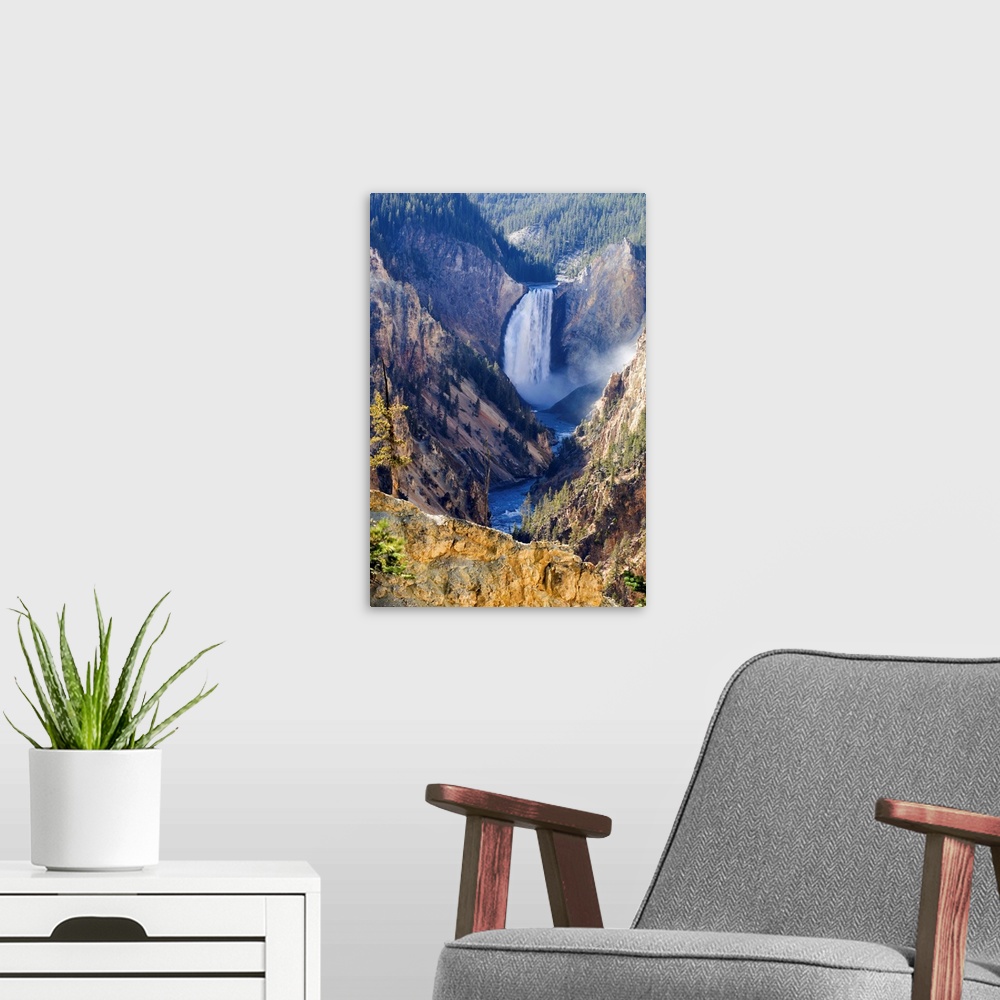 A modern room featuring Sunlit sulphuric rock of the cliffs surrounding the Lower Falls of the Yellowstone River in the G...