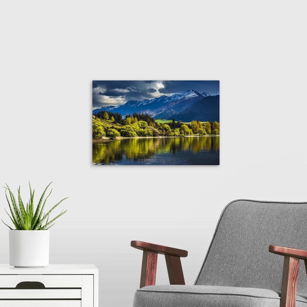 A modern room featuring Sunlit trees along the lake shore with moutain range at Glendhu Bay in the Otago Region of New Ze...