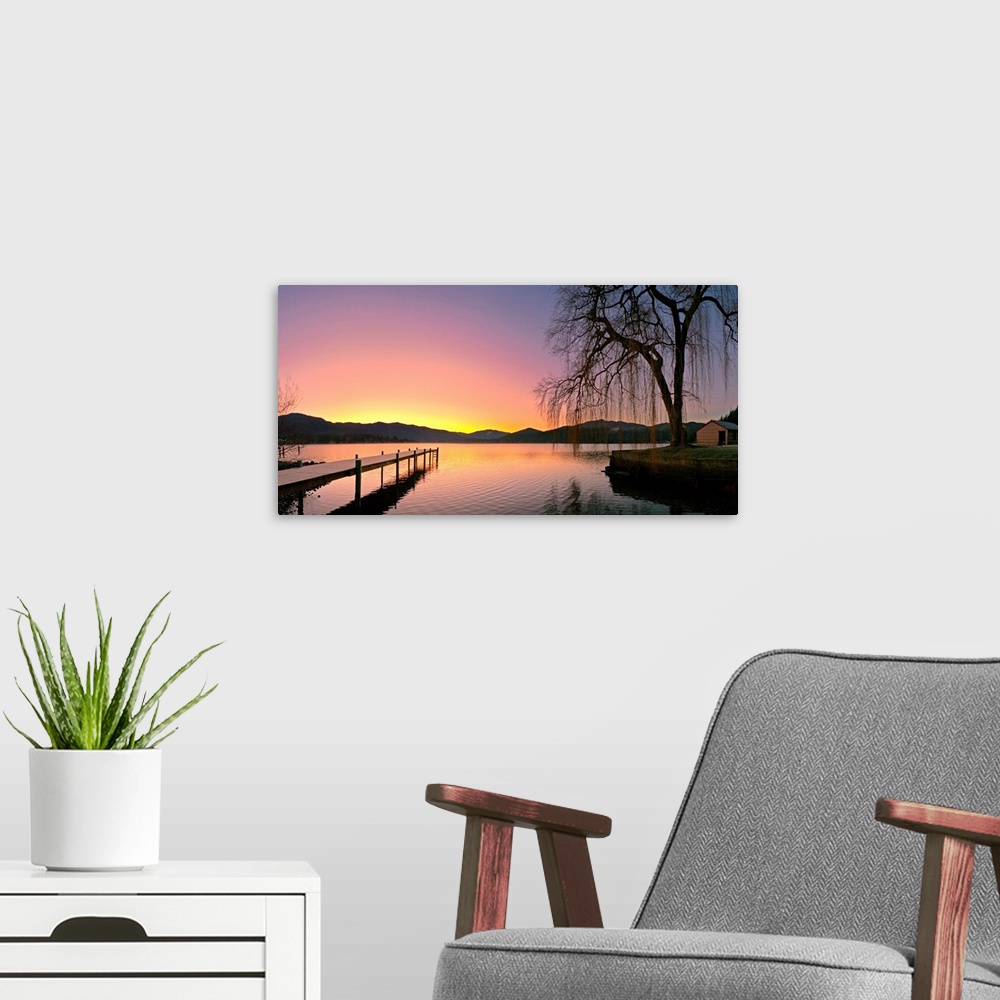 A modern room featuring Photograph of pier stretching into the water at early morning with mountains in the distance.  Th...