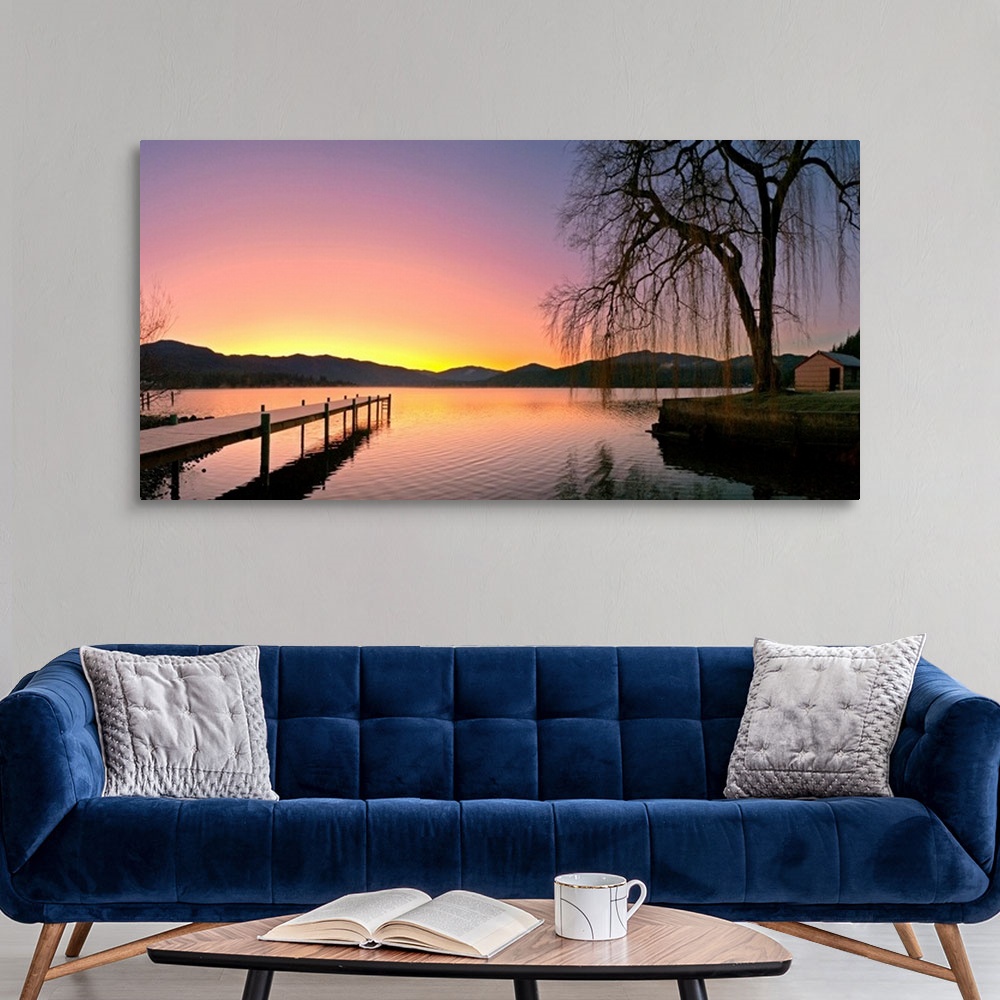 A modern room featuring Photograph of pier stretching into the water at early morning with mountains in the distance.  Th...