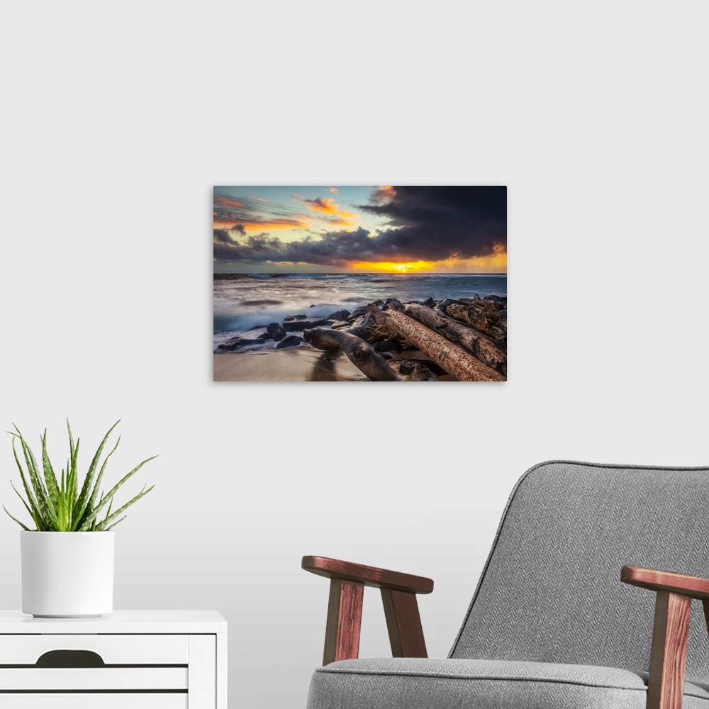 A modern room featuring Sunrise over beach and ocean with a storm cloud and rain in the distance; Kauai, Hawaii, United S...