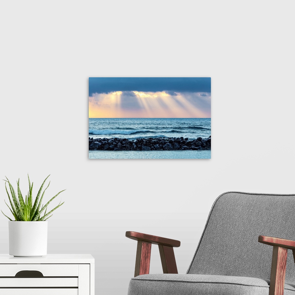A modern room featuring Sunrise over Lydgate Beach and the ocean from the coast of Kauai with a breakwater; Kapaa, Kauai,...