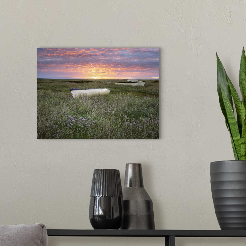 A modern room featuring Sunrise over small boats on the salt marsh surrounded by sea lavender.
