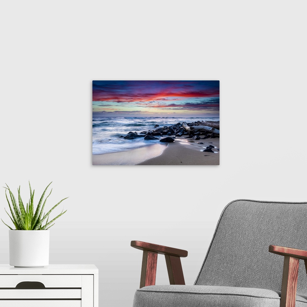 A modern room featuring Sunrise over the ocean from the coast of Kauai; Kapaa, Kauai, Hawaii, United States of America