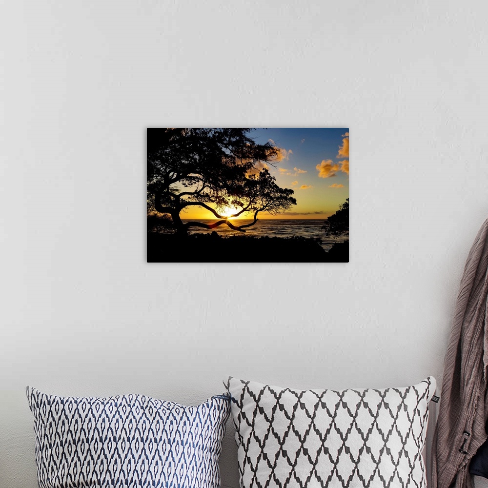 A bohemian room featuring Sunrise over the ocean from the coast of Kauai; Kauai, Hawaii, United States of America