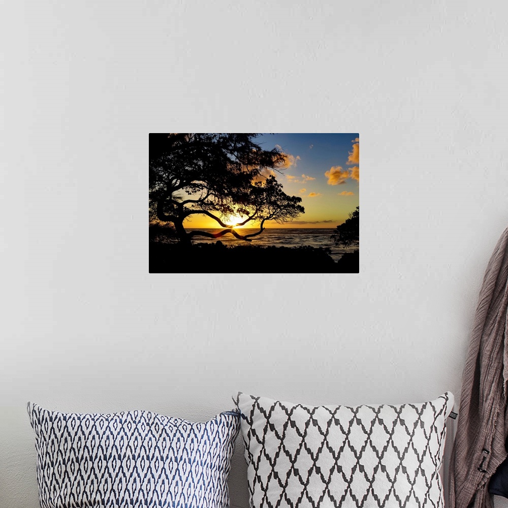 A bohemian room featuring Sunrise over the ocean from the coast of Kauai; Kauai, Hawaii, United States of America