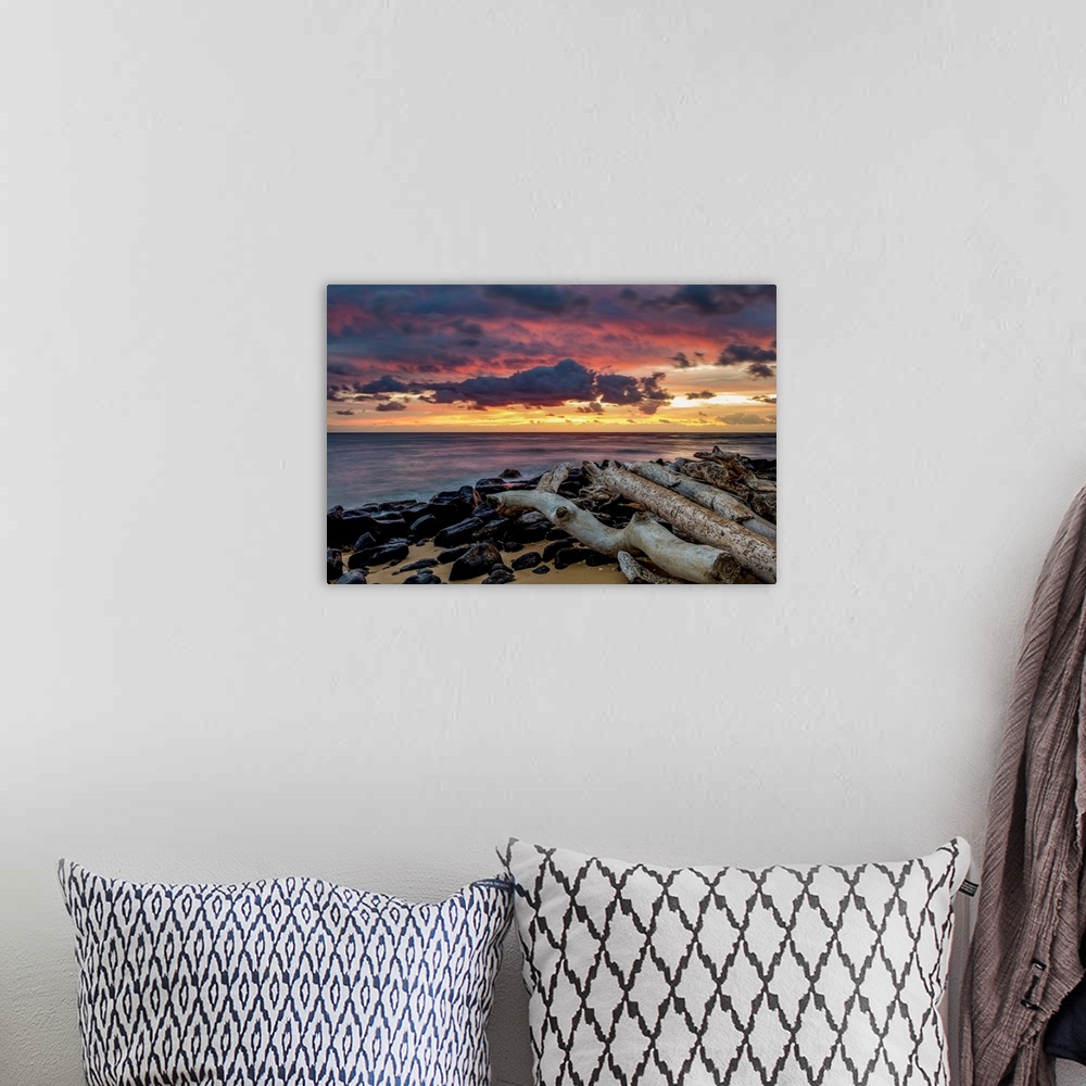 A bohemian room featuring Sunrise over the Pacific Ocean from the shore of Lydgate Beach; Kapaa, Kauai, Hawaii, United Stat...