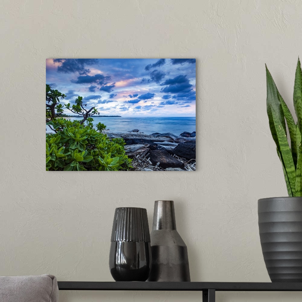 A modern room featuring Sunrise over the Pacific Ocean from the rocks on the shore of Lydgate Beach; Kapaa, Kauai, Hawaii...