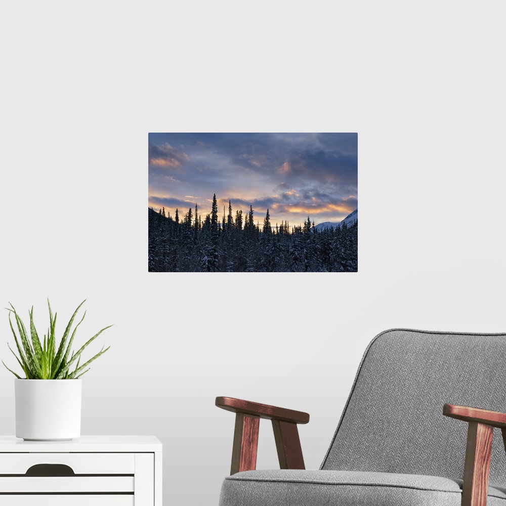 A modern room featuring Sunset colors the sky after a cold winter day, Whitehorse, Yukon, Canada.