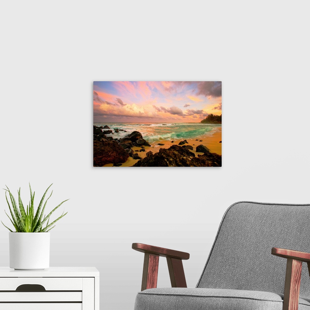 A modern room featuring Photograph taken over rocks that line a beach and looking out onto a sunset lit sky.