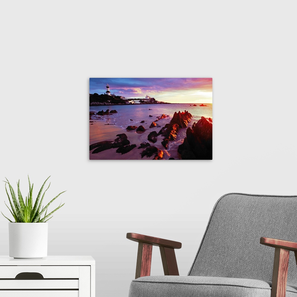 A modern room featuring Sunset Over Beach With Lighthouse