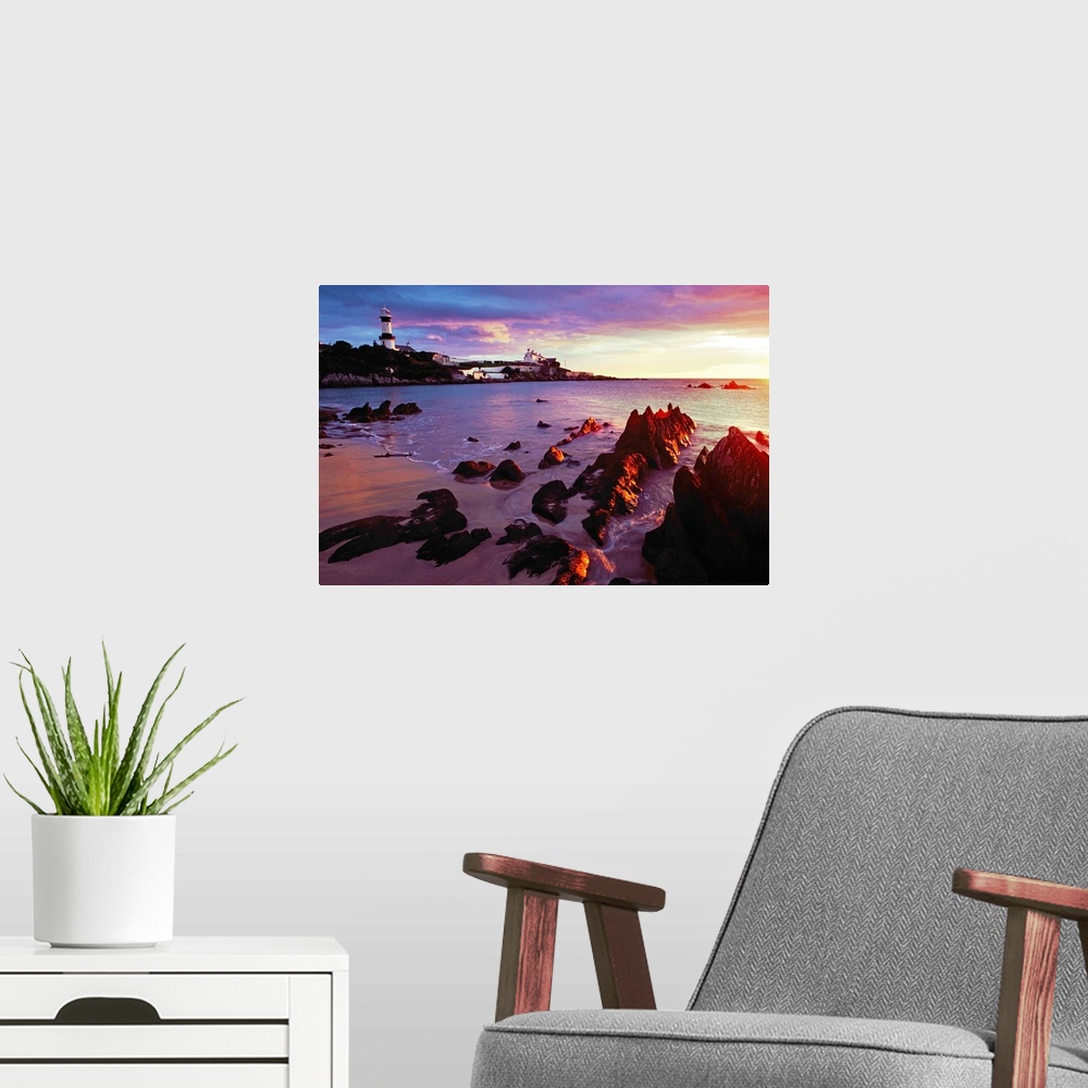 A modern room featuring Sunset Over Beach With Lighthouse