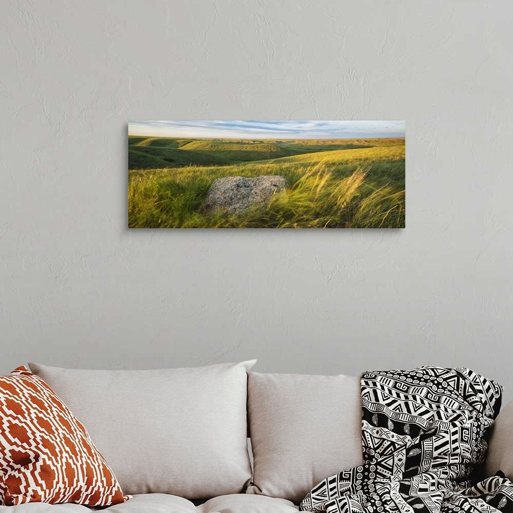 A bohemian room featuring Sunset Over The Coulees And Buttes Of Grasslands National Park With Erratic In Foreground; Saskat...