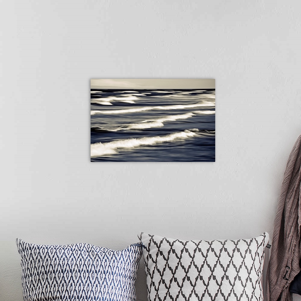 A bohemian room featuring Big photo on canvas of waves breaking up close in the ocean.