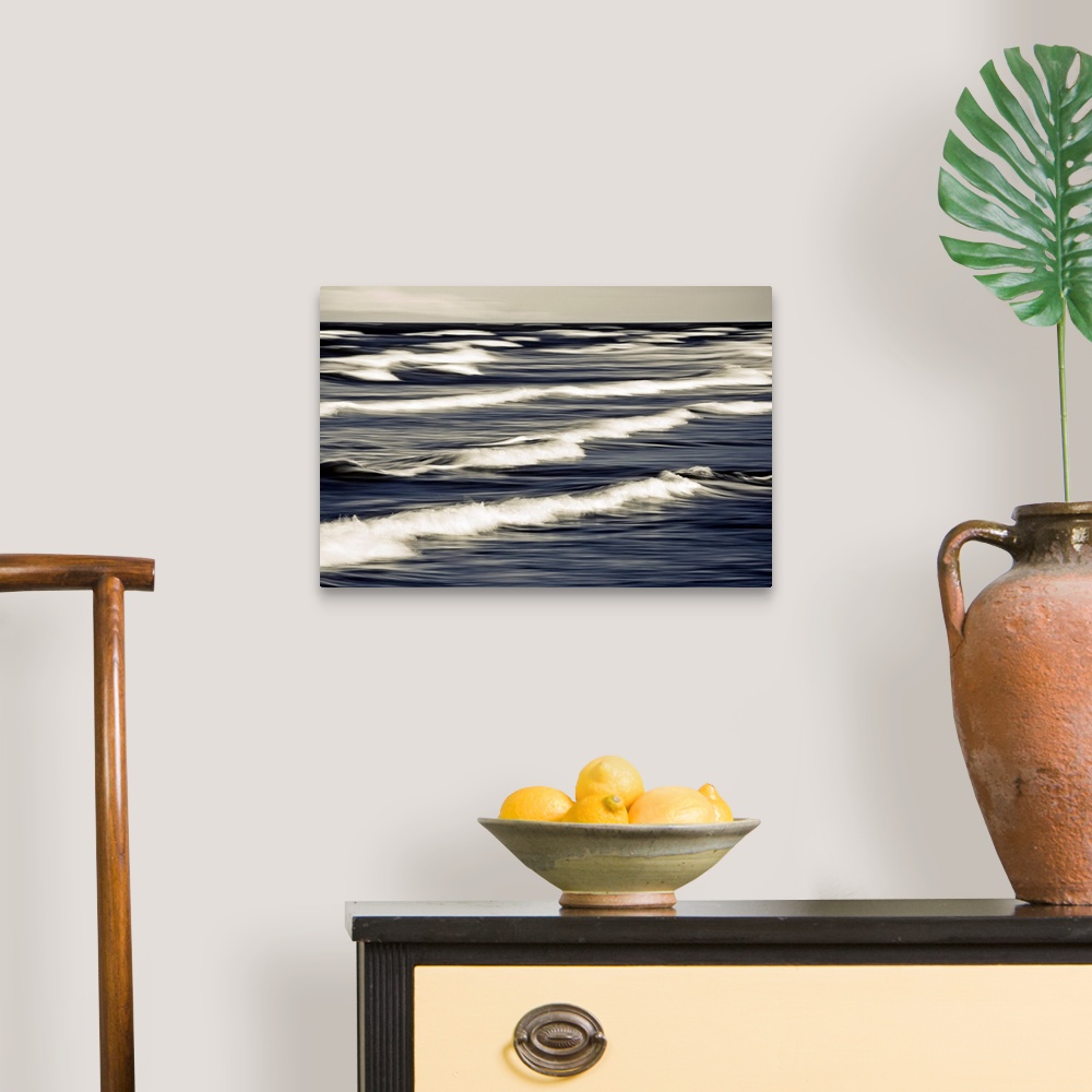 A traditional room featuring Big photo on canvas of waves breaking up close in the ocean.