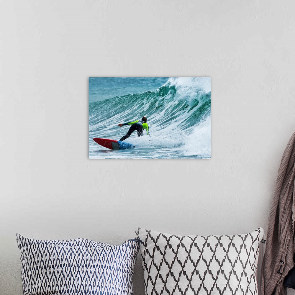 A bohemian room featuring Surfer catching a wave. Tarifa, Cadiz, Andalusia, Spain.
