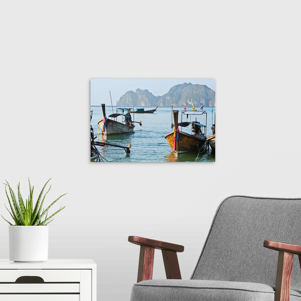 A modern room featuring Thailand, Koh Phi Phi, Longtail boats along the shoreline, Mountains in distance