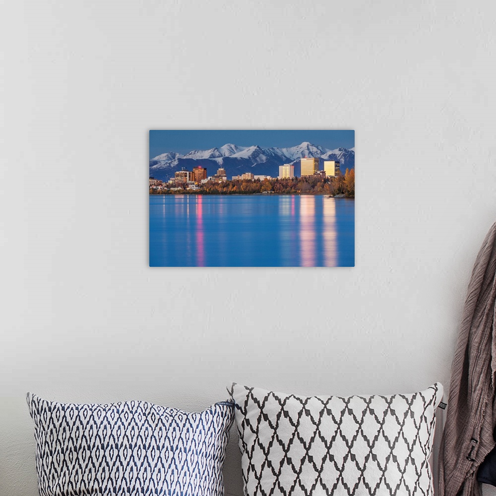 A bohemian room featuring The Anchorage Skyline with the city lights reflected in the water of Knik Arm at high tide, Snow ...