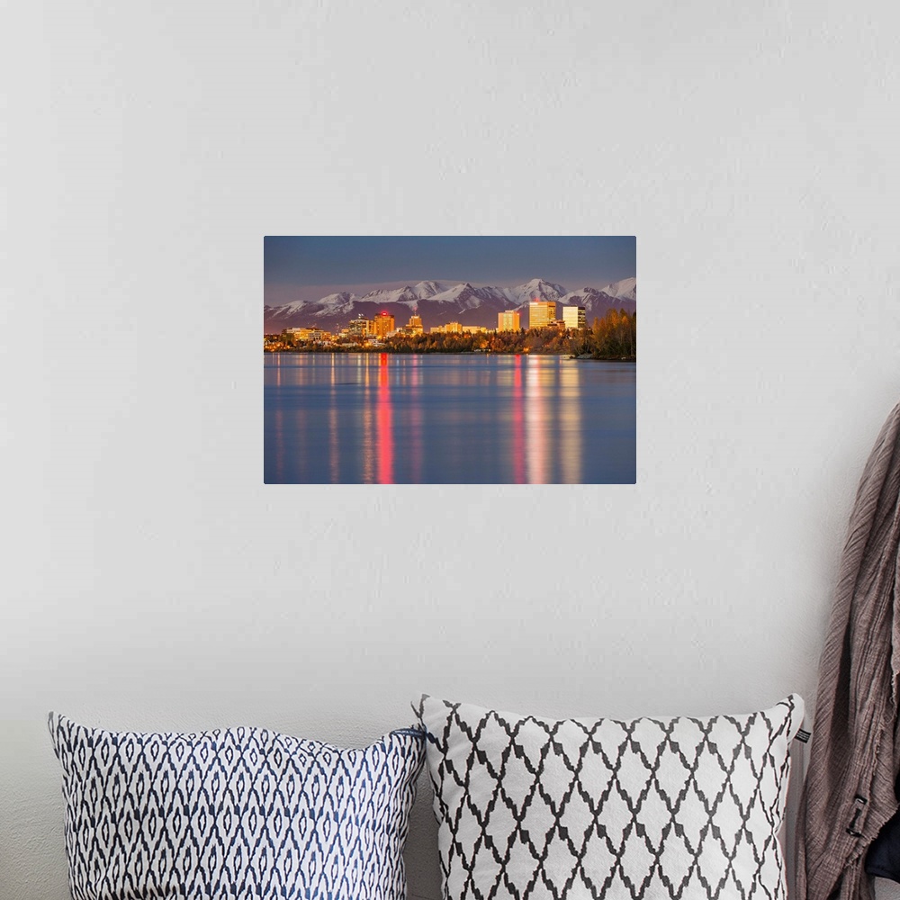 A bohemian room featuring The Anchorage Skyline with the city lights reflected in the water of Knik Arm at high tide, Snow ...
