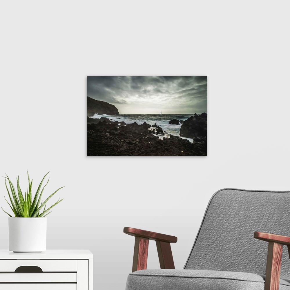 A modern room featuring Rugged landscape along the Atlantic coast with a yacht in a storm; Sao Miguel Island, Azores, Por...