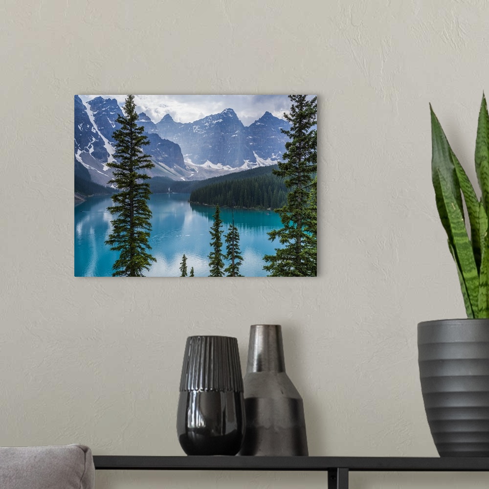 A modern room featuring Stunning view of the rugged Canadian rocky mountain peaks and a tranquil turquoise Moraine Lake w...