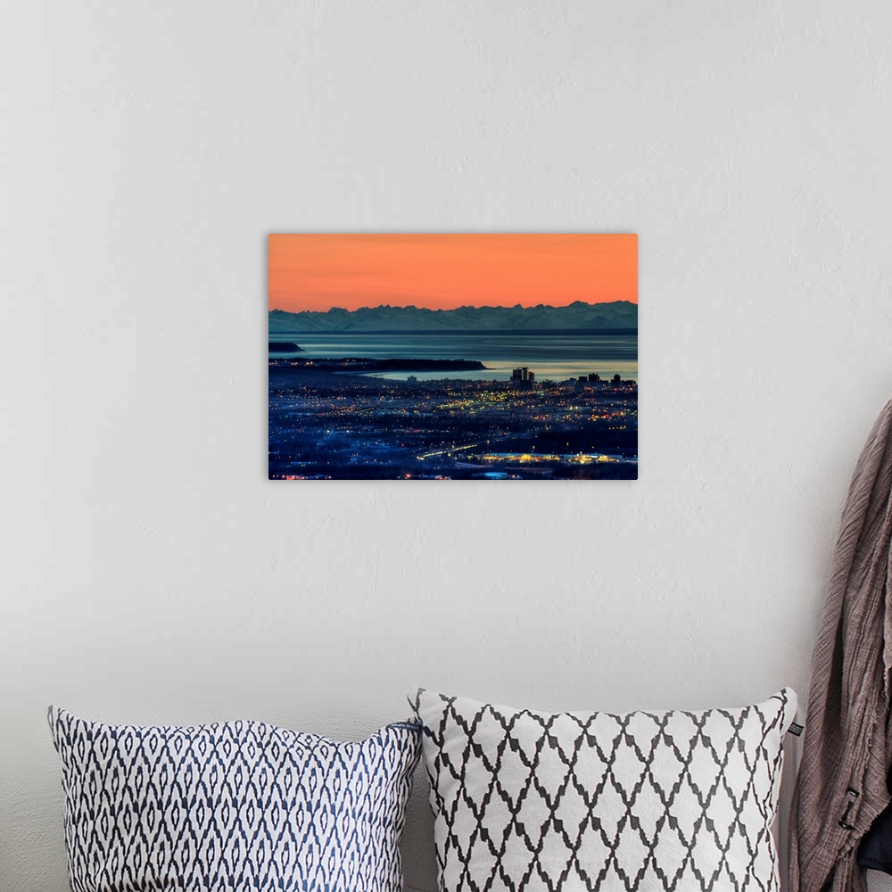 A bohemian room featuring The city of Anchorage Alaska at sunset with Cook Inlet in the background