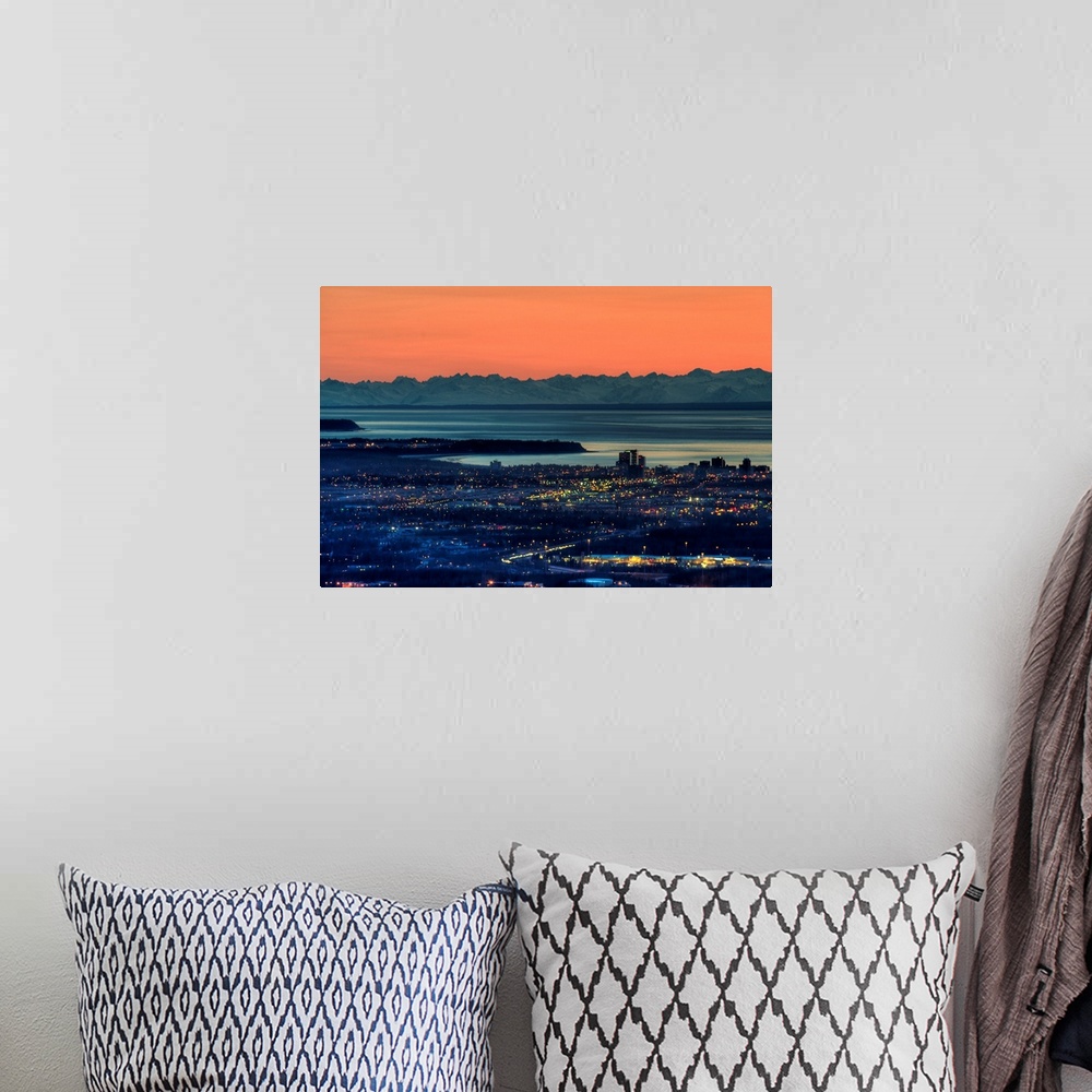 A bohemian room featuring The city of Anchorage Alaska at sunset with Cook Inlet in the background