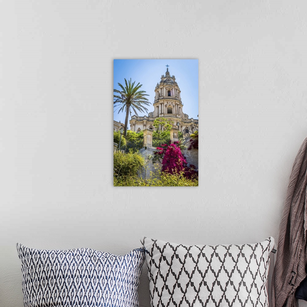 A bohemian room featuring The dome of the baroque Cathedral of San Giorgio with gardens in historical Modica in the Provnic...