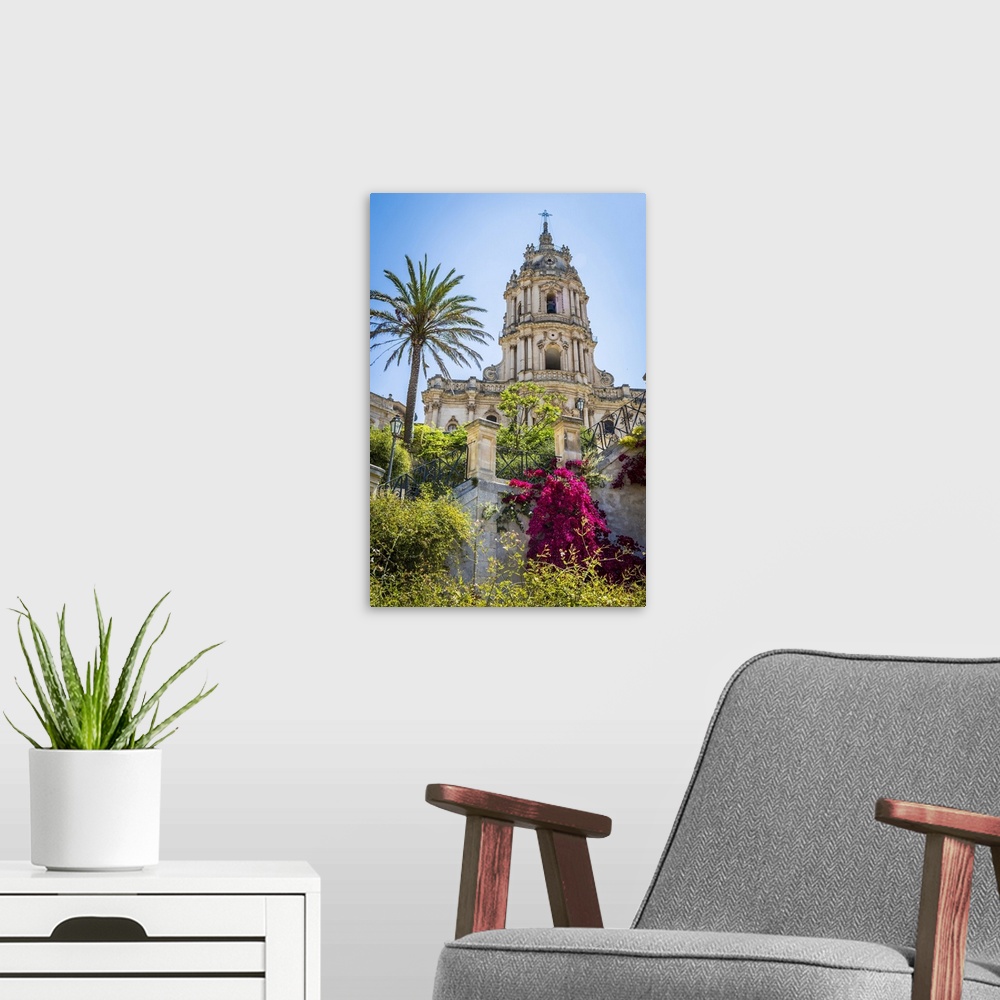 A modern room featuring The dome of the baroque Cathedral of San Giorgio with gardens in historical Modica in the Provnic...