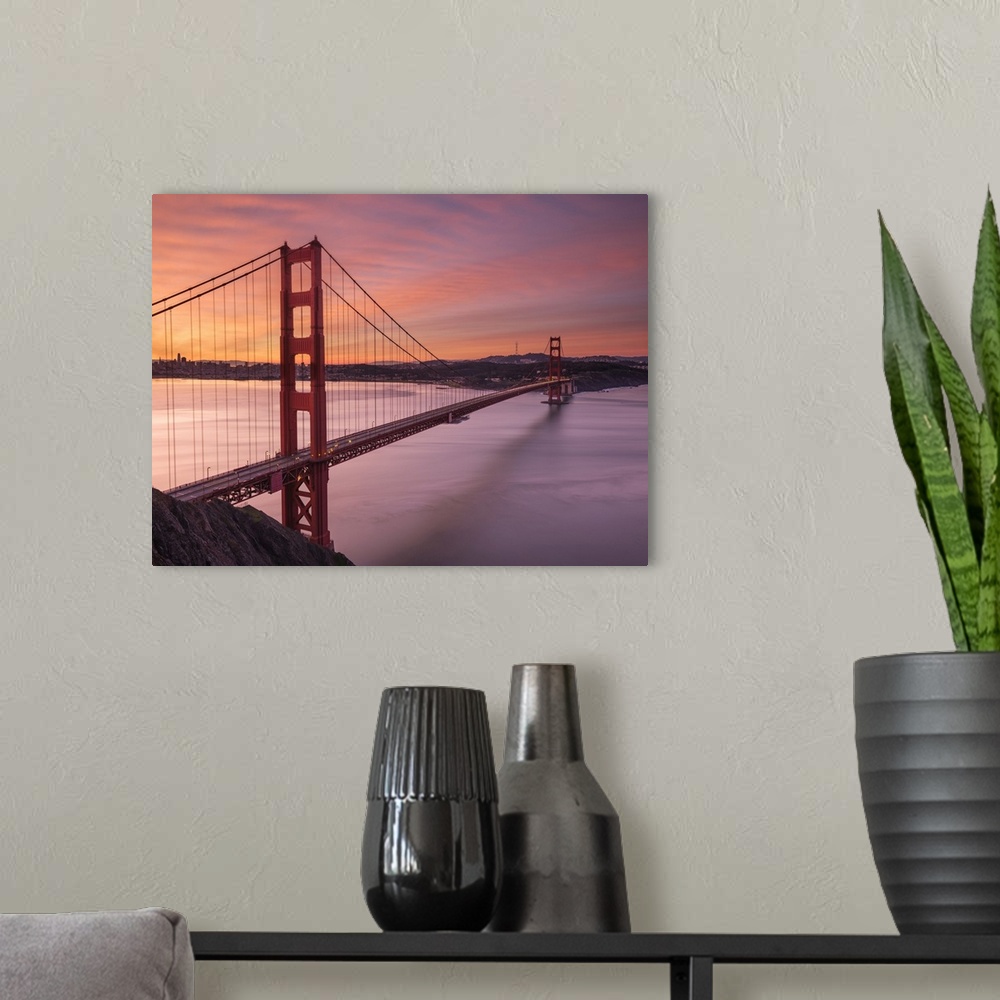 A modern room featuring The Golden Gate Bridge in San Francisco at sunrise.