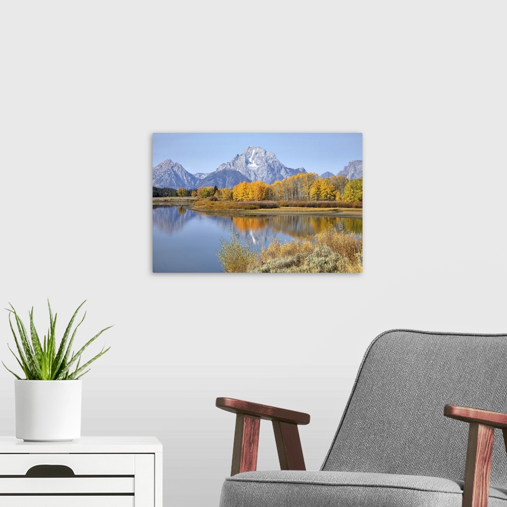 A modern room featuring The Grand Tetons in Grand Teton National Park reflecting fall colors in the Snake River, Wyoming,...