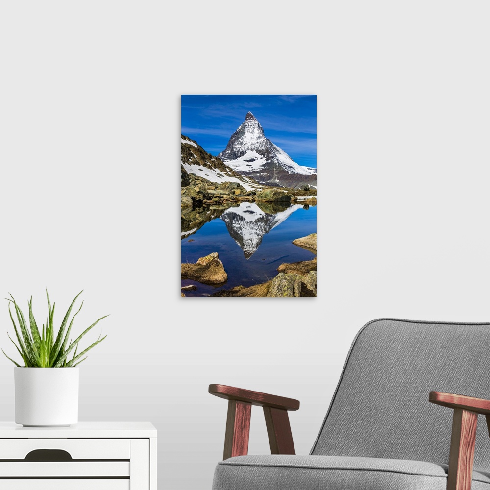 A modern room featuring The Matterhorn reflected in a lake near Riffelsee at Zermatt, Switzerland
