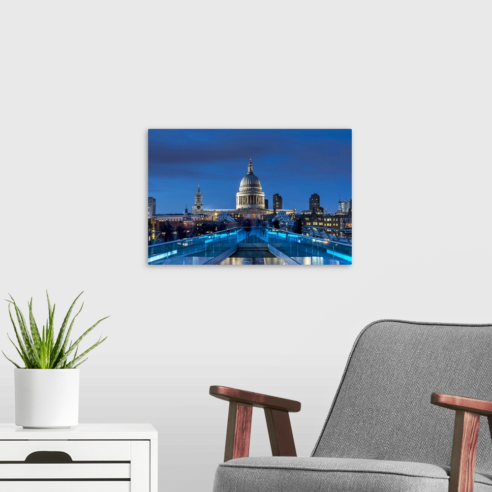 A modern room featuring The Millennium footbridge and St Paul's Cathedral at night.