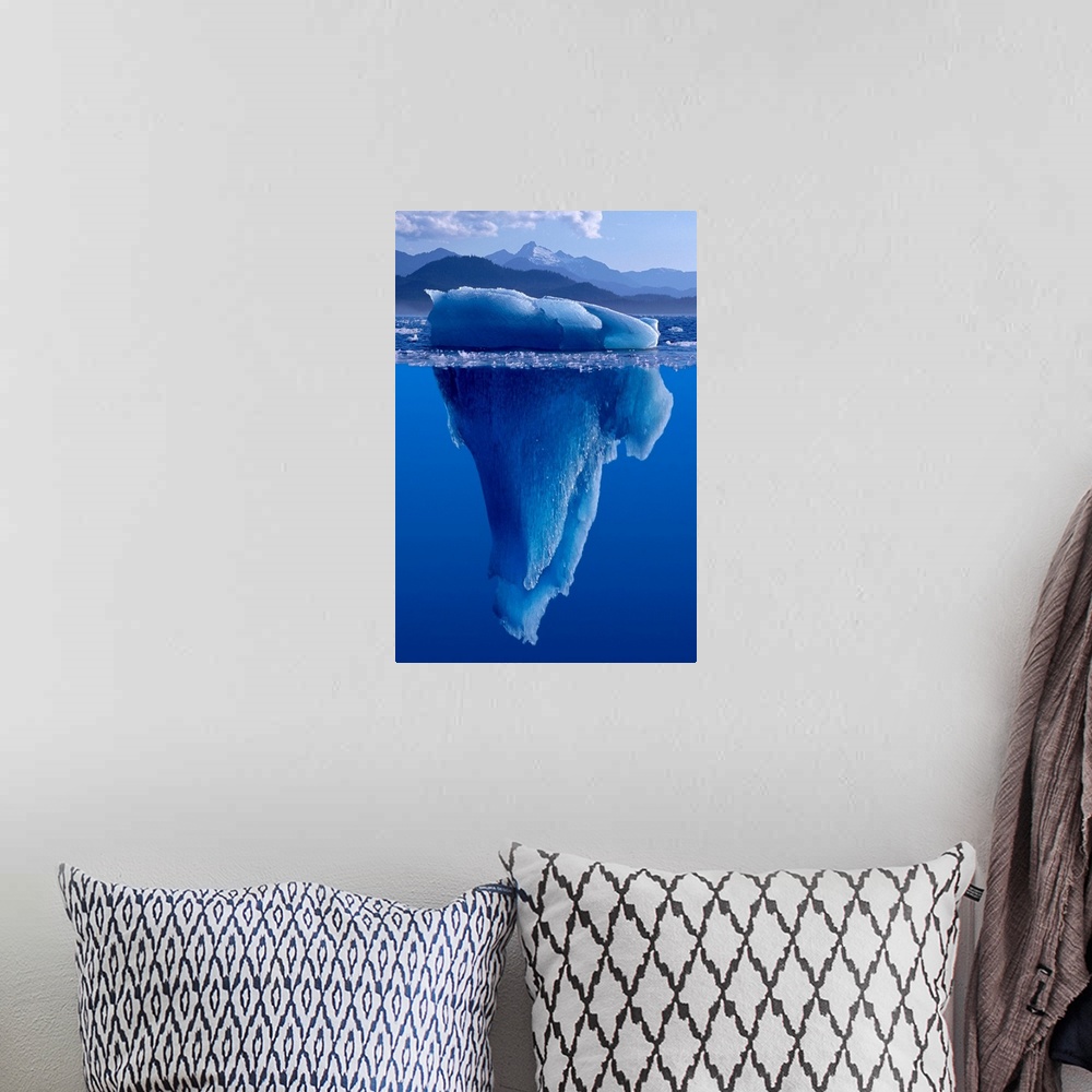 A bohemian room featuring A composite photograph of a large Iceberg as seen from under and above the water.