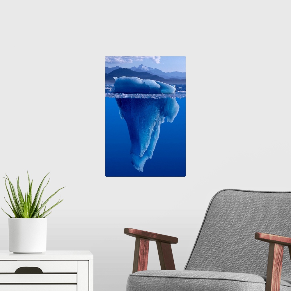 A modern room featuring A composite photograph of a large Iceberg as seen from under and above the water.