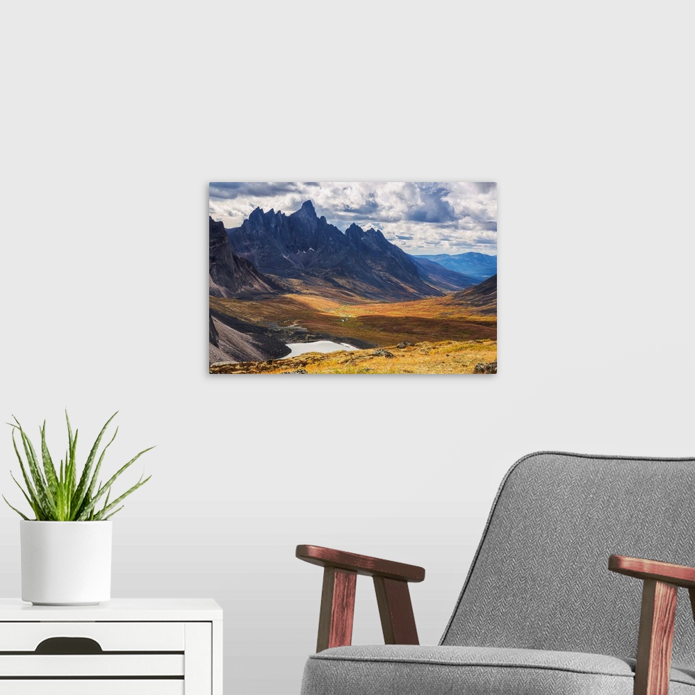 A modern room featuring In the Yukon's North country, Tombstone mountain stands out above the tundra and surrrounding lan...