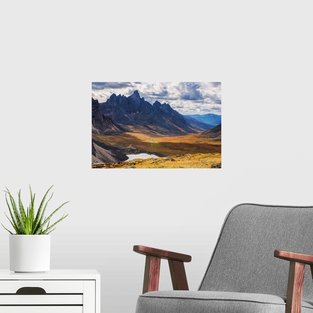 A modern room featuring In the Yukon's North country, Tombstone mountain stands out above the tundra and surrrounding lan...