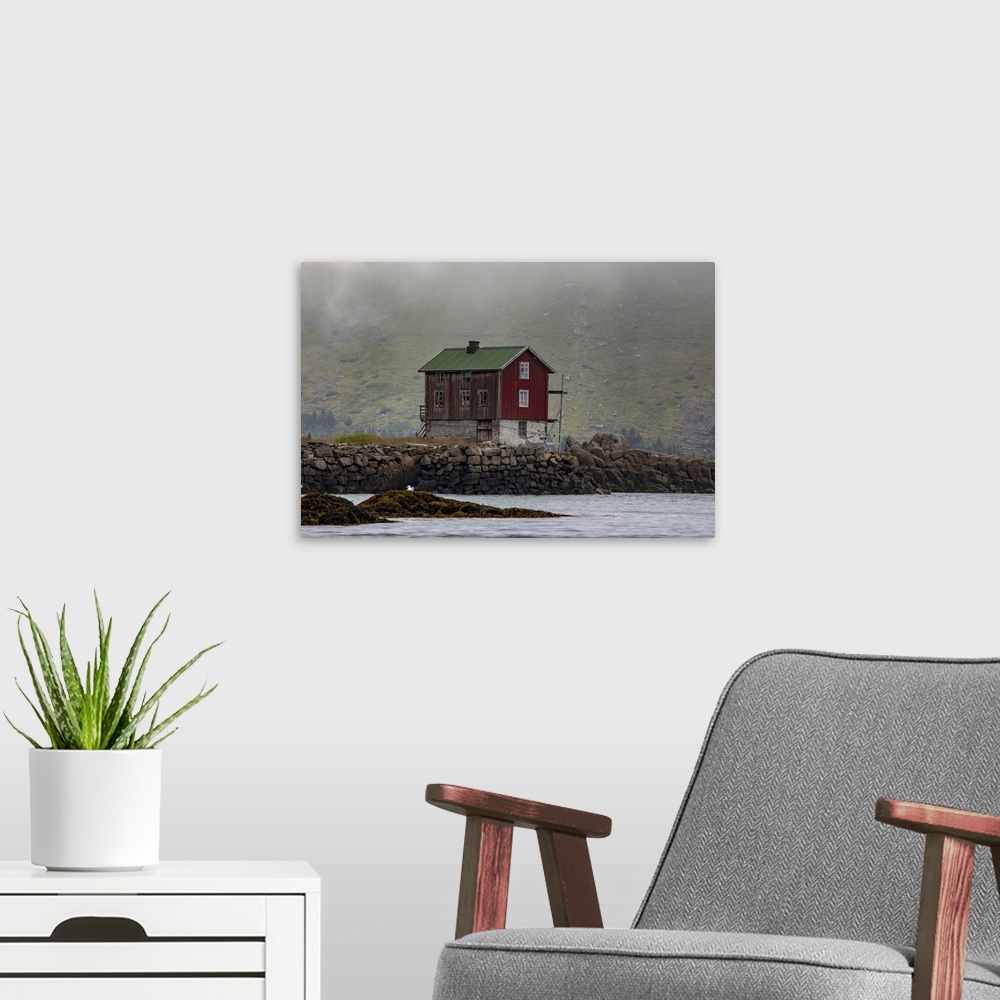 A modern room featuring Traditional fishing village house next to the shoreline in Lofoten, Lofoten, Arctic Circle, Norway