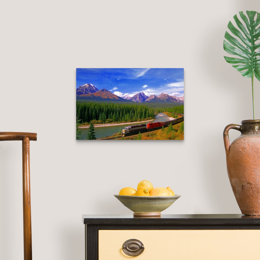 A traditional room featuring Big canvas photo art of a train running through the Canadian countryside with forests surrounding...