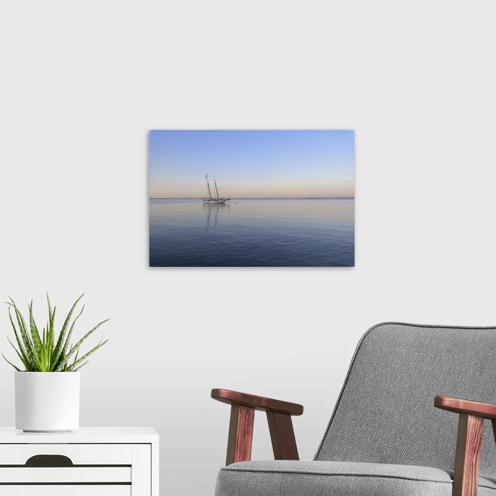 A modern room featuring Two masted sailboat anchored on Lake Garda (Lago di Garda) at dawn at Bardolinoin Veneto, Italy